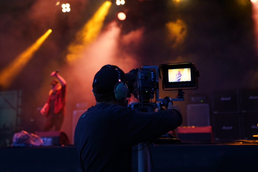 camera man filming a concert